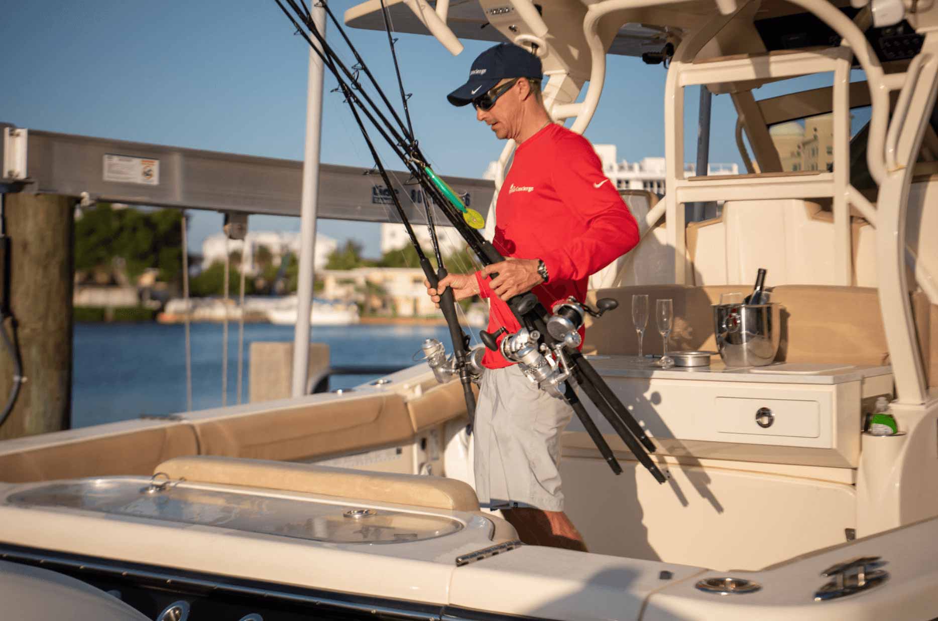 Captain Gabe on the boat holding fishing rods boat concierge services
