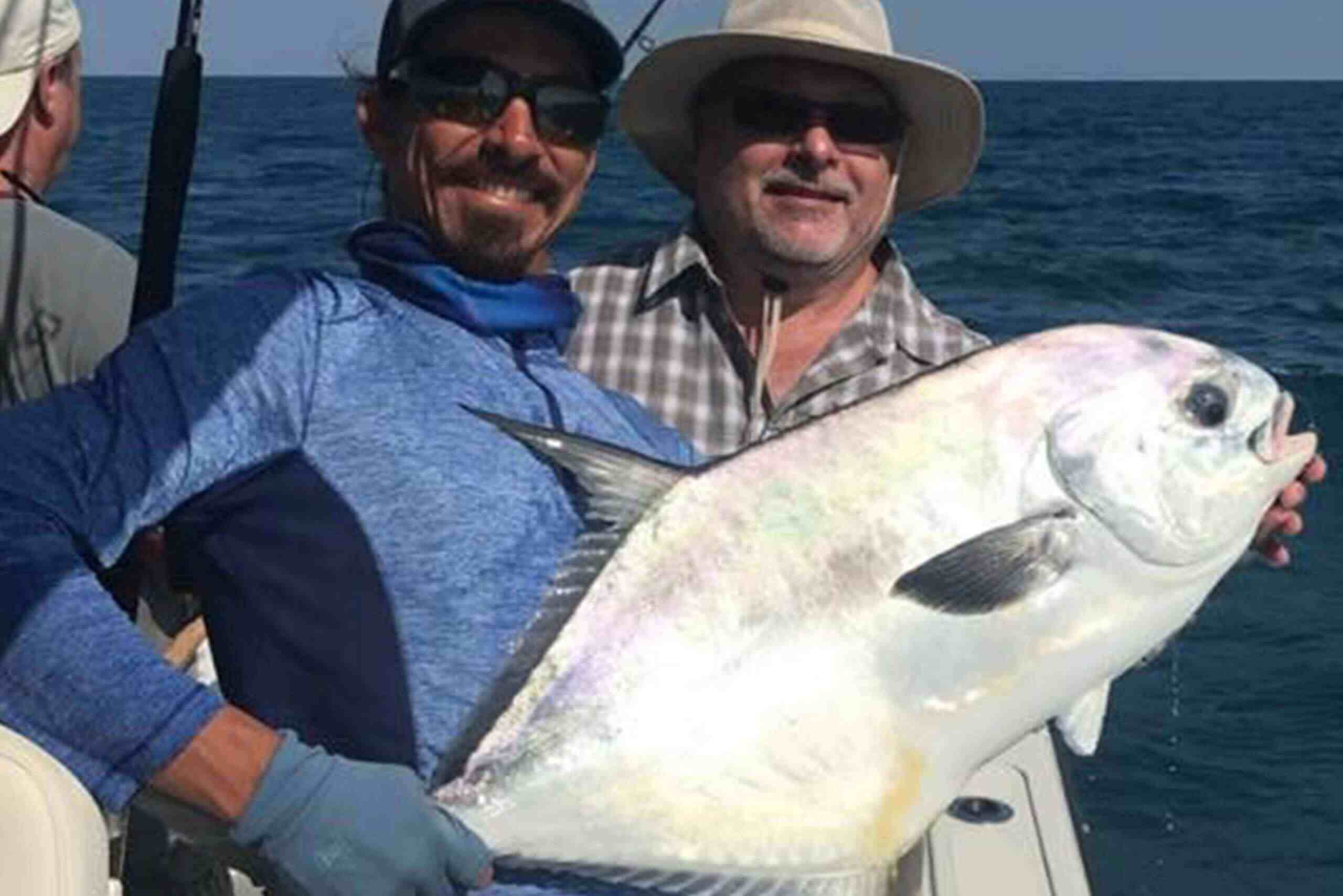 two men caught a big fish boat charter services 2